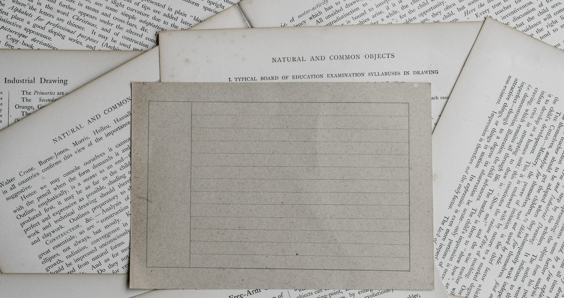 A blank writing sheet sits on tops of lots of written letters