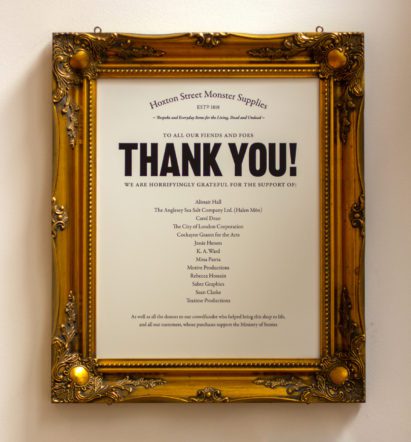 Golden frame containing a list of people and companies who have supported the second store